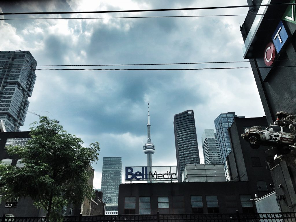 A photograph from the streets in Toronto showing the CN Tower, Bell Media, CTV and the CP24 truck art installation.