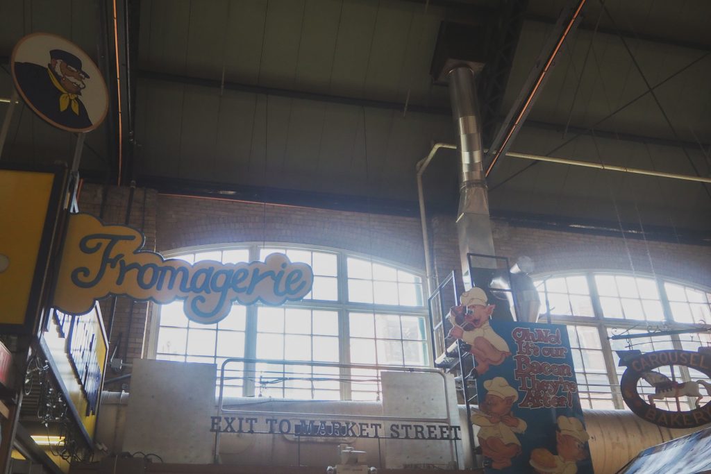 From my camera roll. A sign reading Fromagerie from inside St. Lawrence Market, and looking up at the industrial windows at the exit to Market Street.
